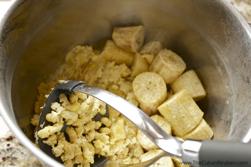 Mashing the boiled plantains.