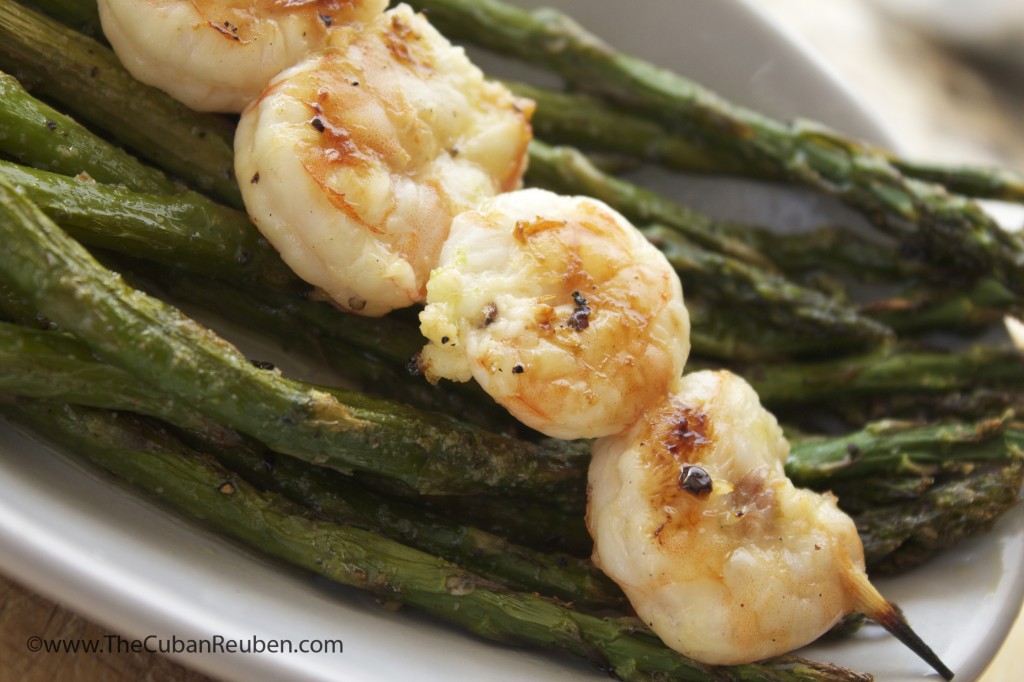 Grilled honey lime shrimp, resting on a bed of charred asparagus.